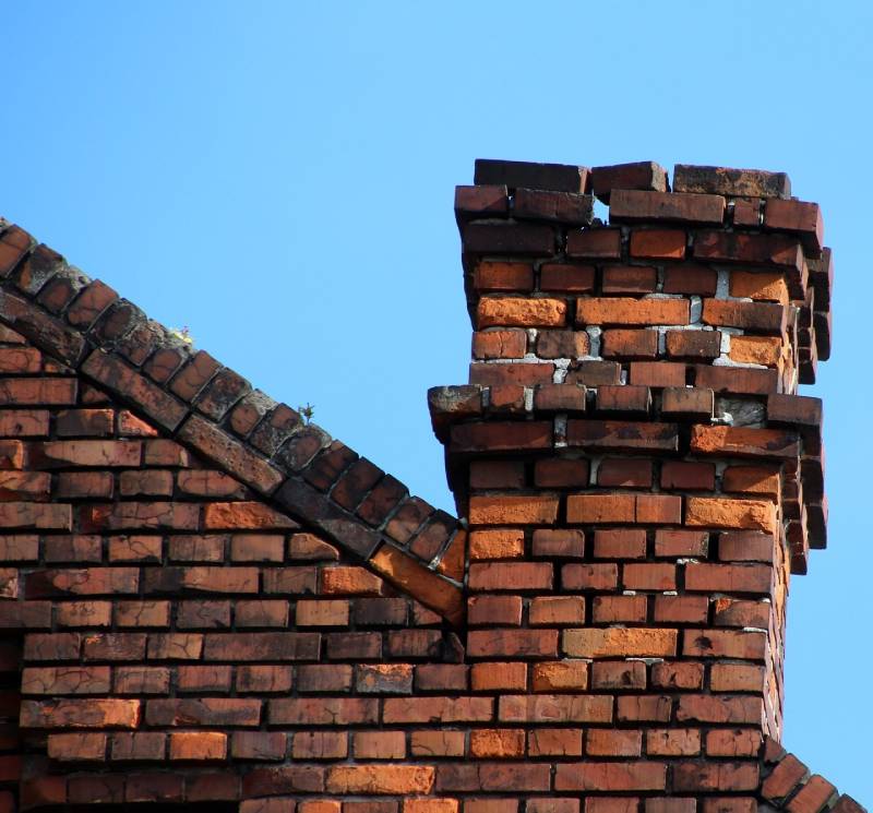 Damaged chimney on an Lake Bluff home showing cracks and missing mortar